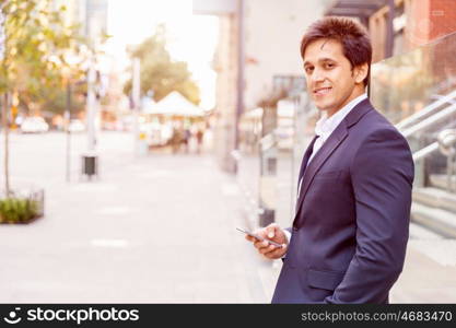 Portrait of confident businessman outdoors. Portrait of confident businessman with his mobile phone outdoors