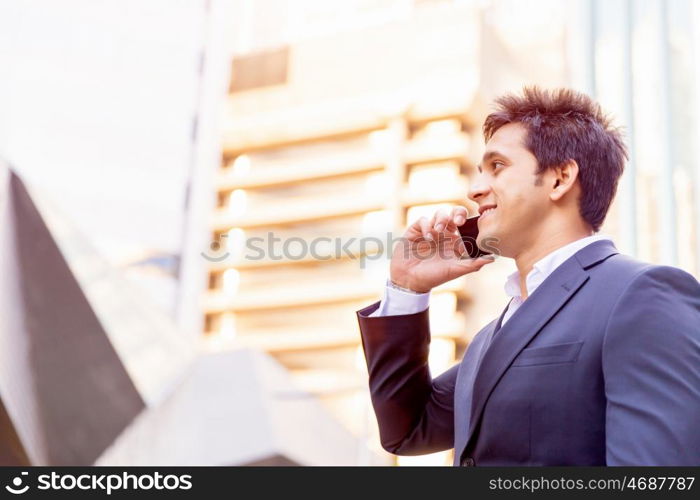 Portrait of confident businessman outdoors. Portrait of confident businessman with his mobile phone outdoors