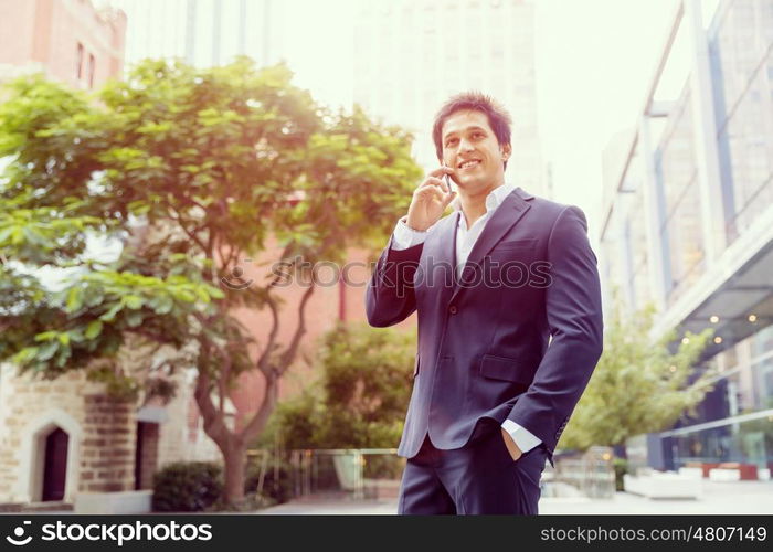 Portrait of confident businessman outdoors. Portrait of confident businessman with his mobile phone outdoors