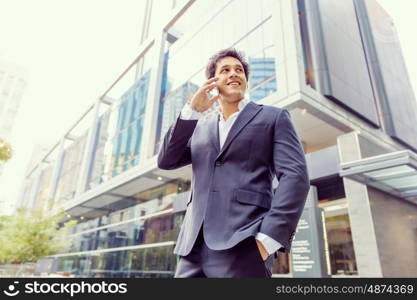 Portrait of confident businessman outdoors. Portrait of confident businessman with his mobile phone outdoors