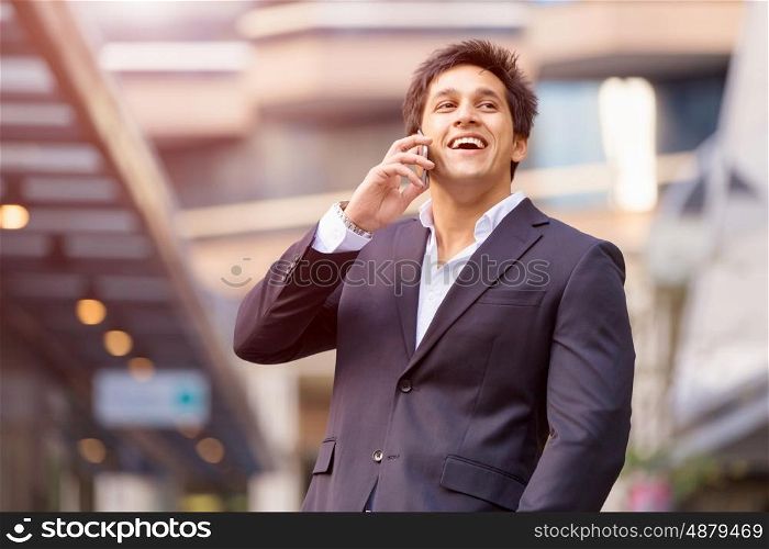Portrait of confident businessman outdoors. Portrait of confident businessman with his mobile phone outdoors