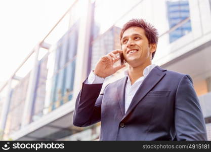 Portrait of confident businessman outdoors. Portrait of confident businessman with his mobile phone outdoors