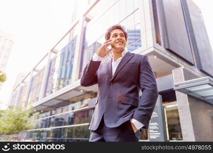 Portrait of confident businessman outdoors. Portrait of confident businessman with his mobile phone outdoors