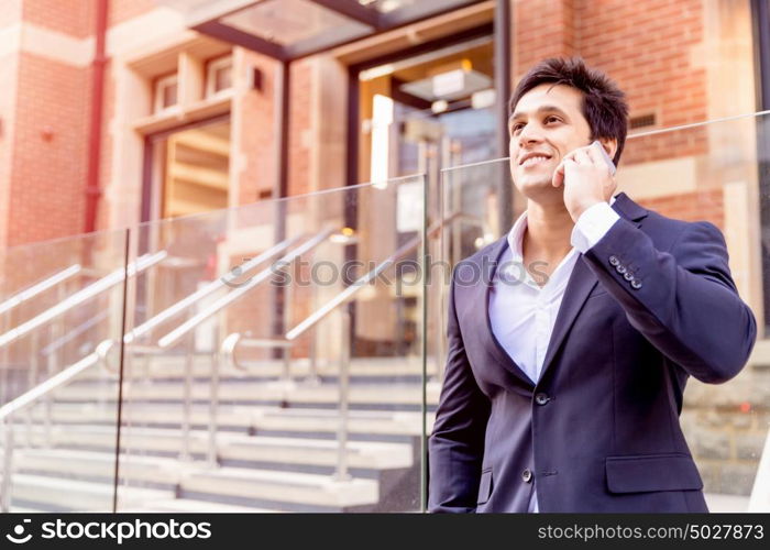 Portrait of confident businessman outdoors. Portrait of confident businessman with his mobile phone outdoors