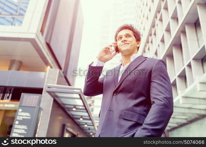 Portrait of confident businessman outdoors. Portrait of confident businessman with his mobile phone outdoors