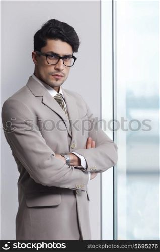 Portrait of confident businessman wearing glasses in office