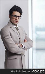 Portrait of confident businessman wearing glasses in office