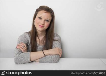 Portrait of confident businesswoman sitting at desk in office