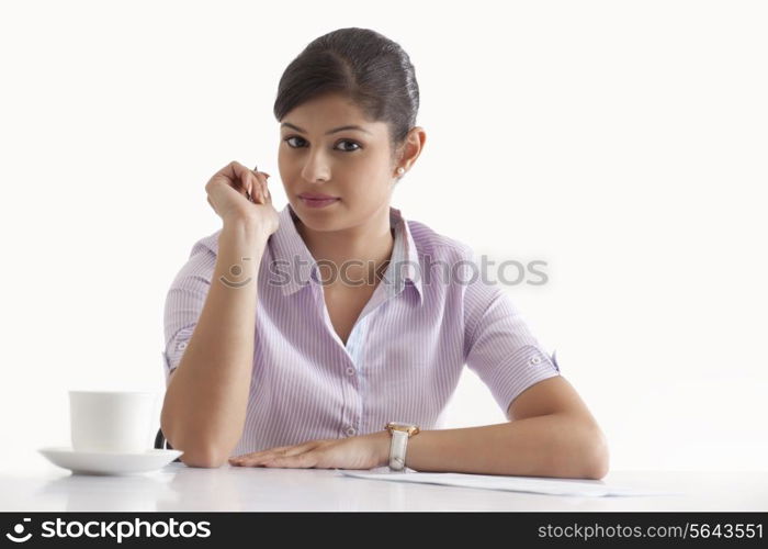 Portrait of confident businesswoman sitting at her desk