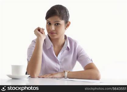 Portrait of confident businesswoman sitting at her desk