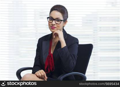 Portrait of confident businesswoman sitting in office