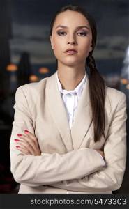 Portrait of confident businesswoman standing arms crossed in office