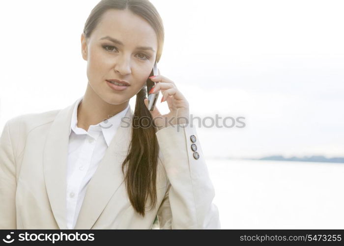 Portrait of confident businesswoman using cell phone outdoors