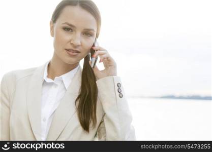 Portrait of confident businesswoman using cell phone outdoors