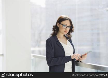 Portrait of confident businesswoman using tablet PC in office
