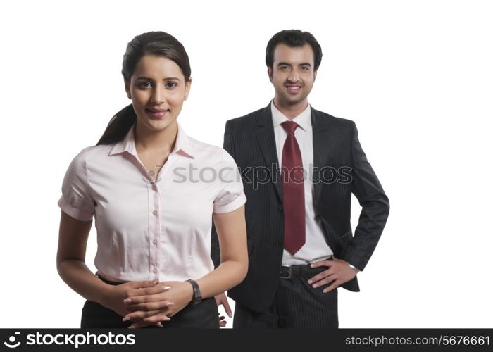 Portrait of confident businesswoman with colleague in background over white background