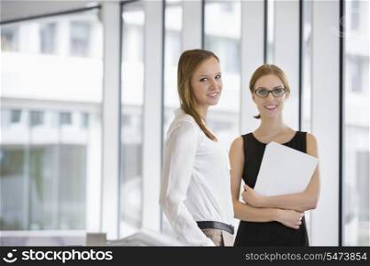 Portrait of confident businesswomen with documents in office