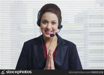 Portrait of confident customer service representative greeting in office