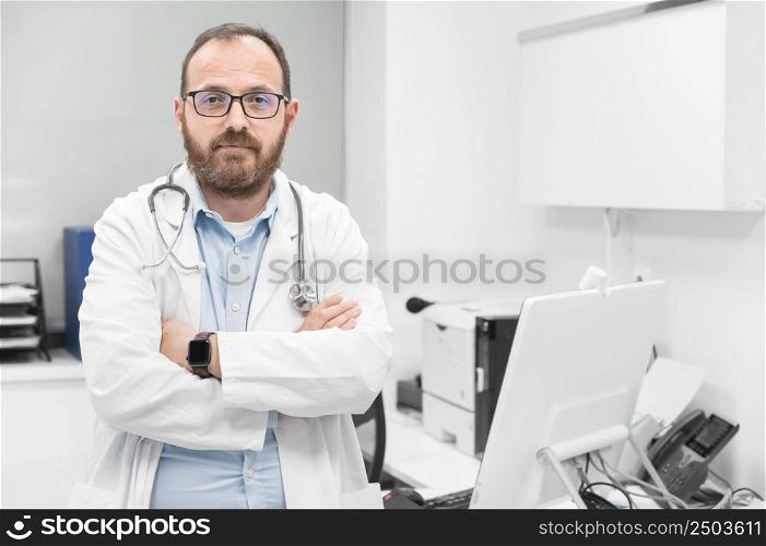 Portrait of confident doctor crossing hands and smiling at camera. High quality photography.. Portrait of confident doctor crossing hands and smiling at camera.