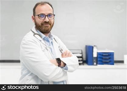 Portrait of confident doctor crossing hands and smiling at camera. High quality photography.. Portrait of confident doctor crossing hands and smiling at camera.
