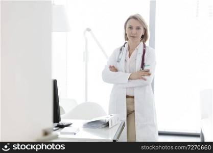 Portrait of confident doctor standing with arms crossed at hospital