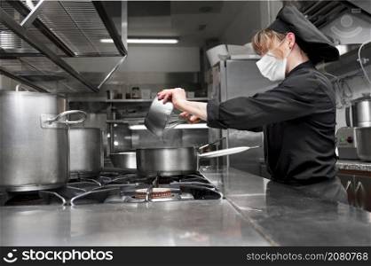 Portrait of confident female chef working in commercial kitchen. High quality photo. Portrait of confident female chef working in commercial kitchen.
