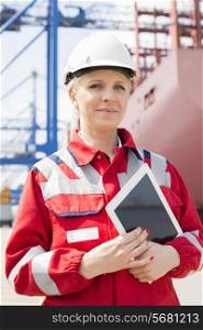 Portrait of confident female engineer holding tablet computer in shipping yard