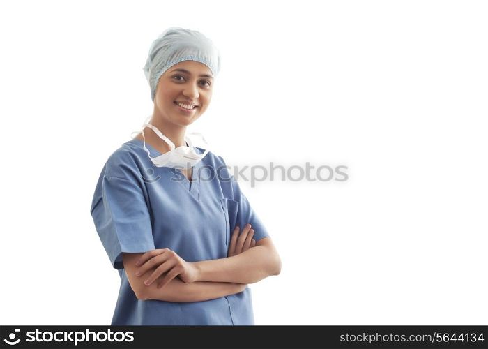 Portrait of confident female surgeon standing over white background