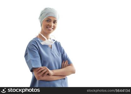 Portrait of confident female surgeon standing over white background