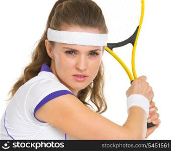 Portrait of confident female tennis player ready to hit ball