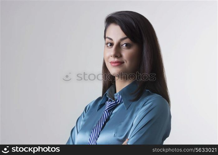 Portrait of confident Indian businesswoman over gray background