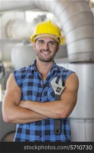 Portrait of confident industrial worker standing arms crossed