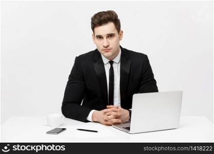 Portrait of confident manager sitting at desk and looking at camera. Portrait of business man working at computer. Successful formal man in his new modern office. Portrait of confident manager sitting at desk and looking at camera. Portrait of business man working at computer. Successful formal man in his new modern office.