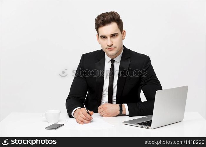 Portrait of confident manager sitting at desk and looking at camera. Portrait of business man working at computer. Successful formal man in his new modern office. Portrait of confident manager sitting at desk and looking at camera. Portrait of business man working at computer. Successful formal man in his new modern office.