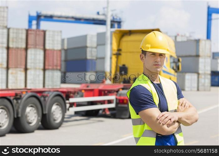 Portrait of confident mid adult man in shipping yard