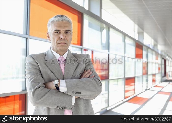 Portrait of confident middle aged businessman at railroad station