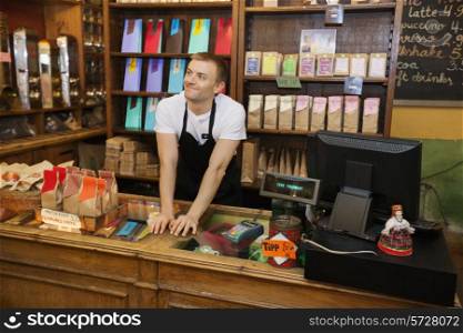 Portrait of confident salesperson in coffee store