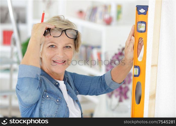 portrait of confident senior woman with diy tool
