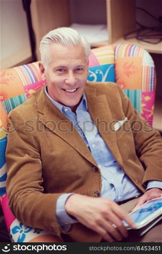 portrait of confident teacher sitting in colorful chair