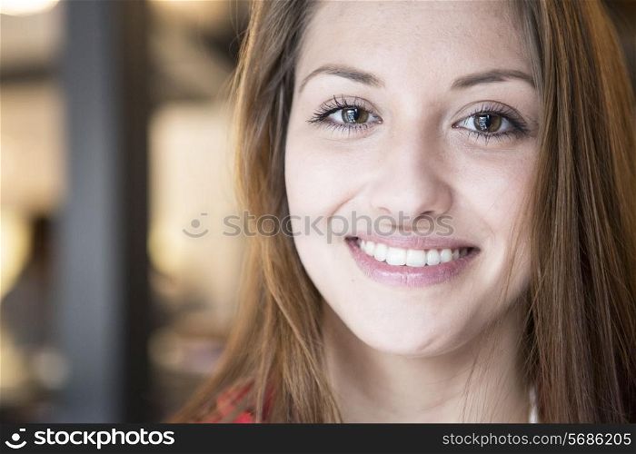 Portrait of confident woman smiling in cafe