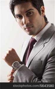 Portrait of confident young business man wearing watch