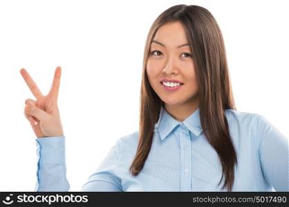 Portrait of confident young business woman showing victory gesture on white background