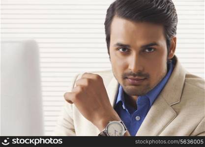 Portrait of confident young businessman at office