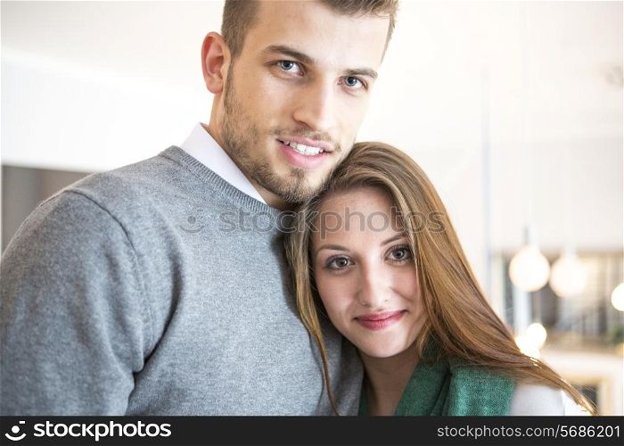 Portrait of confident young couple at cafe
