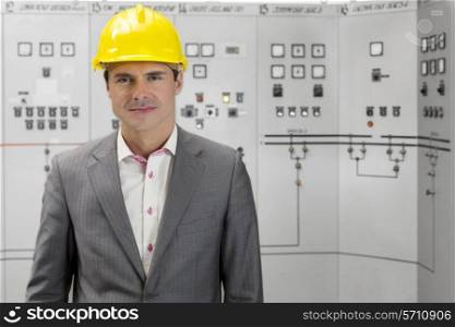 Portrait of confident young male supervisor in control room
