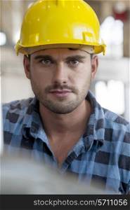 Portrait of confident young male worker in industry