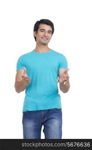 Portrait of confident young man gesturing over white background