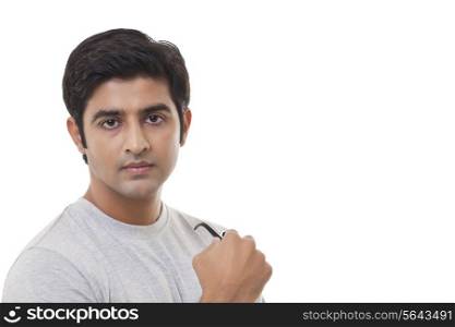 Portrait of confident young man over white background