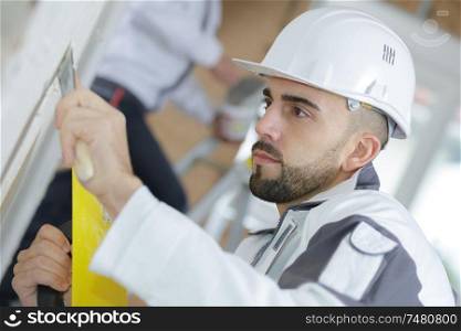 portrait of construction worker plastering wall