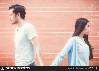 Portrait of couple asian young woman and man outdoor with relationship problem together, emotion unhappy concept.